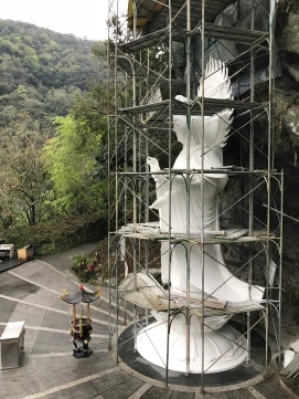 A large sculpture undergoing renovation.