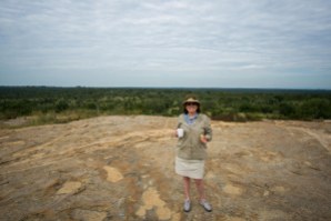 Mom enjoying her coffee atop a huge rock outcrop.
